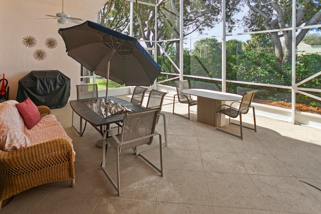 sunroom featuring ceiling fan