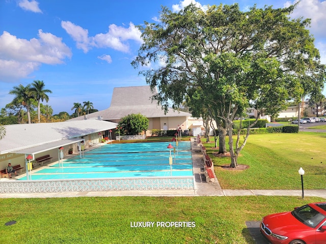 view of pool featuring a yard