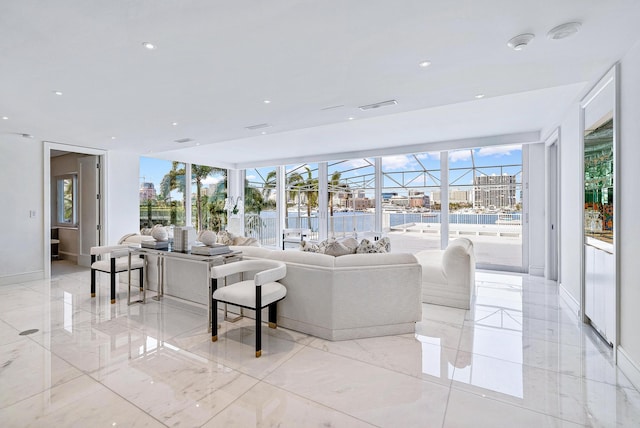 tiled living room with floor to ceiling windows