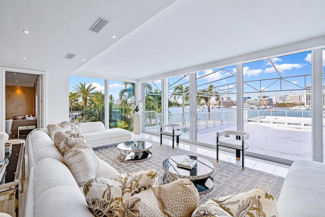 tiled living room with plenty of natural light and expansive windows