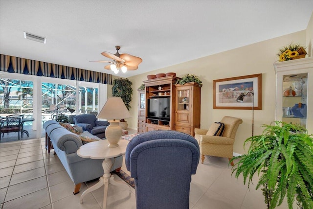 living room featuring ceiling fan and light tile floors