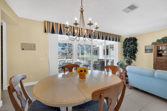 dining space with light tile floors and a notable chandelier