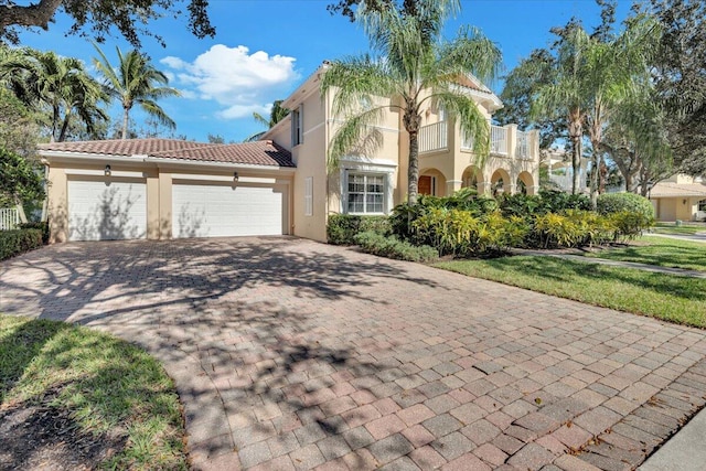 mediterranean / spanish house featuring a garage