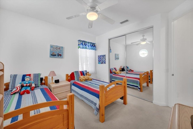 bedroom with light carpet, a closet, and ceiling fan