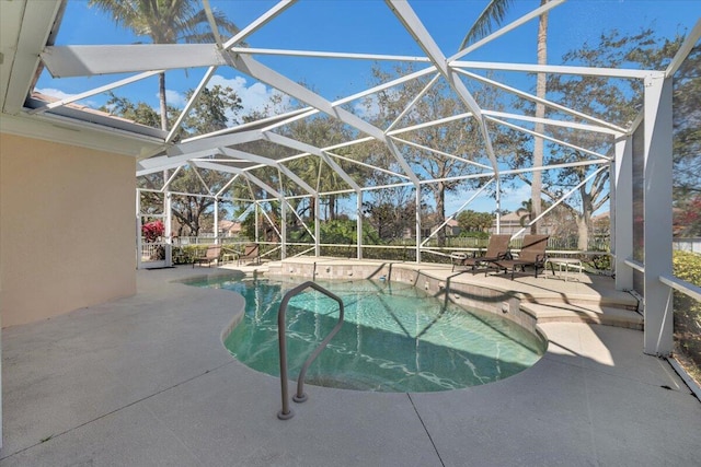 view of swimming pool featuring glass enclosure and a patio