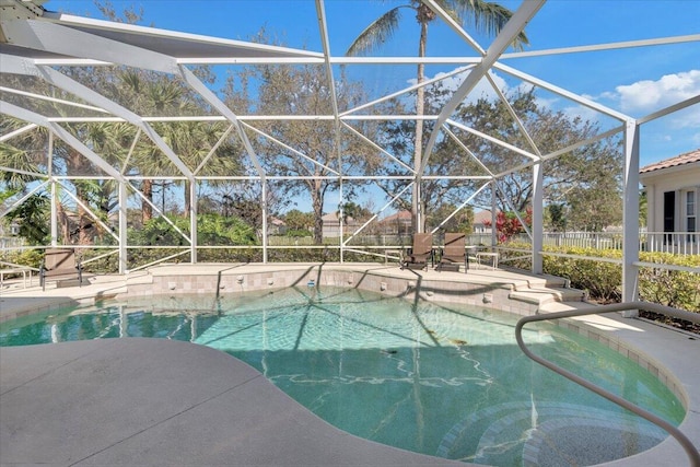 view of swimming pool with a lanai and a patio