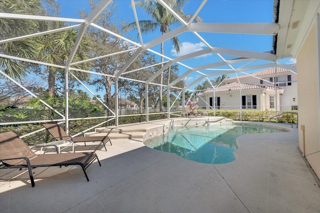 view of swimming pool featuring a patio and a lanai