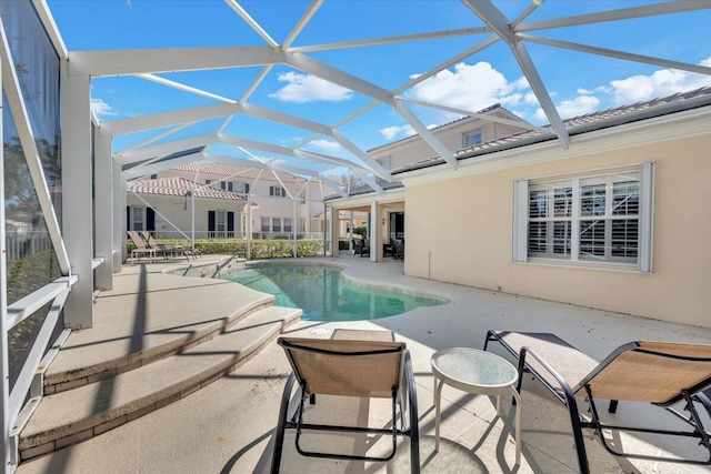 view of pool with a patio and a lanai