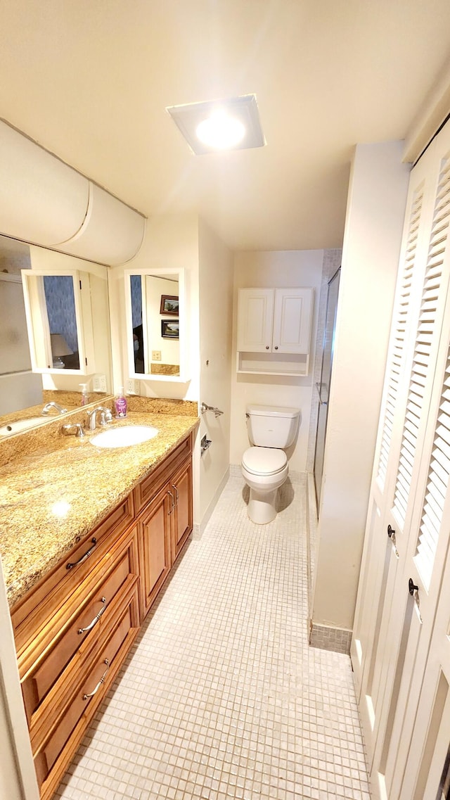 bathroom with vanity, toilet, and an enclosed shower