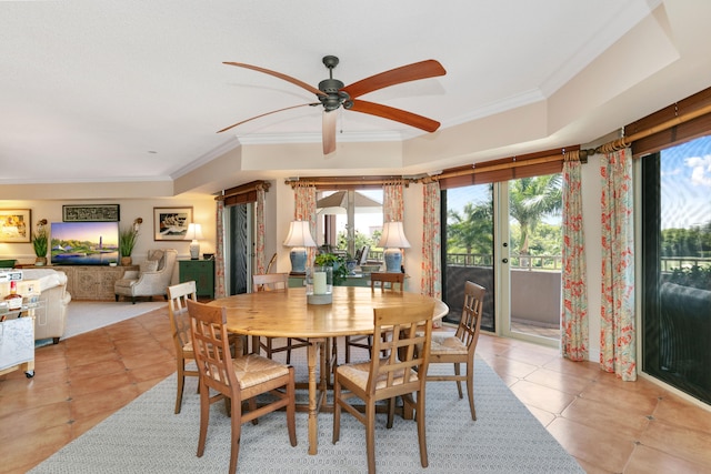 tiled dining room featuring ceiling fan, crown molding, and a tray ceiling