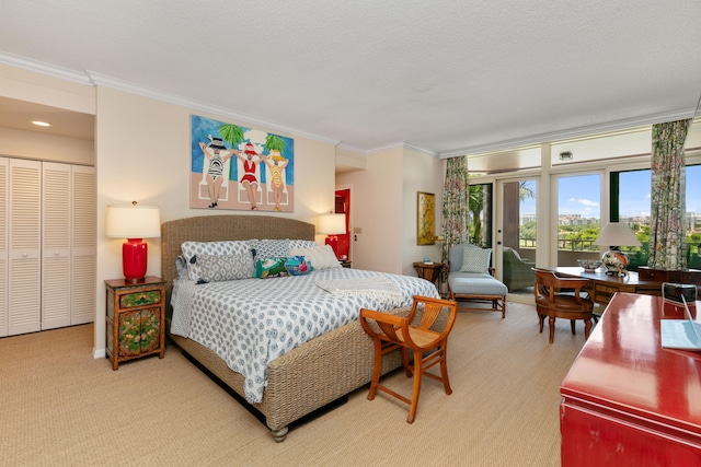 bedroom featuring light carpet, ornamental molding, a closet, and a textured ceiling