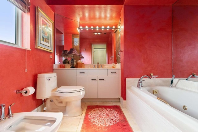 bathroom featuring toilet, a bidet, tiled bath, tile floors, and vanity