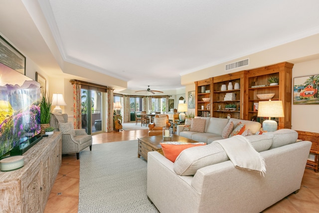 living room featuring ornamental molding, ceiling fan, and light tile floors