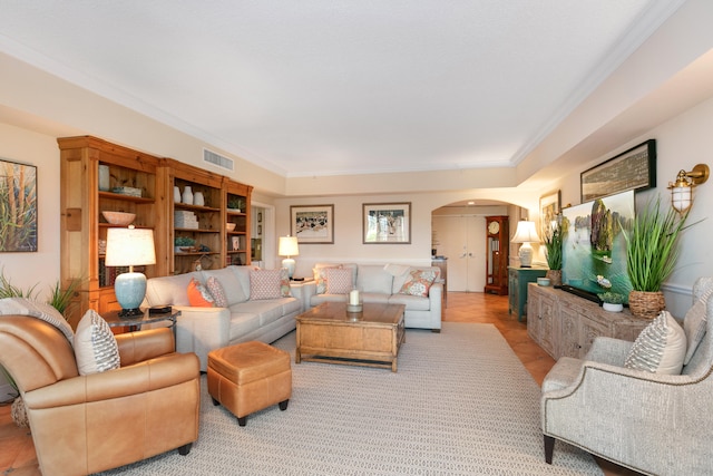 living room featuring light hardwood / wood-style floors and crown molding