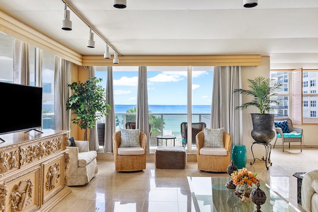 tiled living room with track lighting and a water view