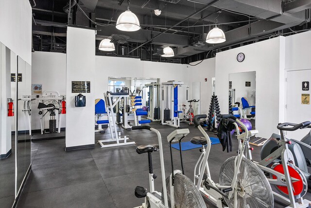 exercise room with a high ceiling