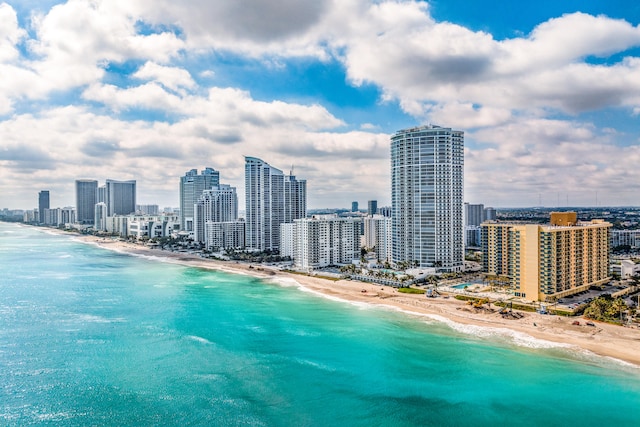 bird's eye view featuring a beach view and a water view