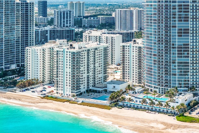 aerial view with a water view and a view of the beach