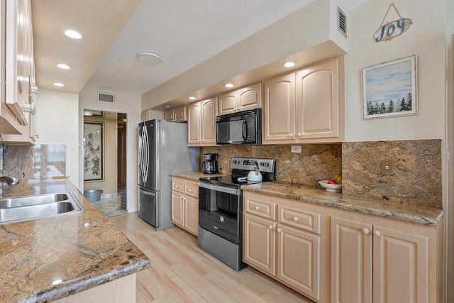 kitchen with light brown cabinets, stainless steel appliances, sink, backsplash, and light stone counters