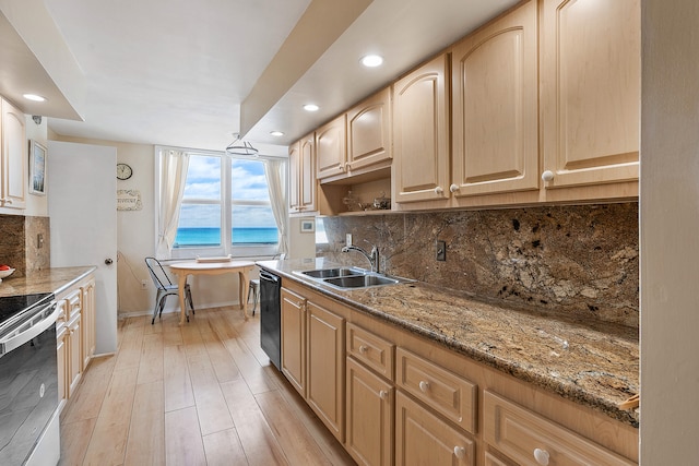 kitchen featuring sink, dishwasher, light hardwood / wood-style flooring, light stone countertops, and tasteful backsplash