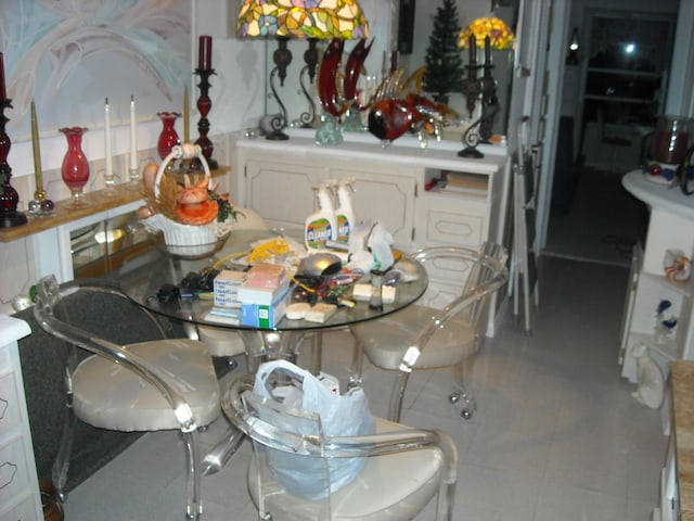 dining area featuring light tile floors