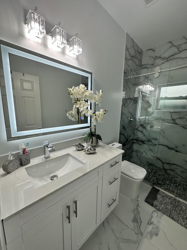 bathroom featuring vanity, toilet, and tiled shower