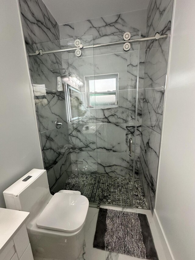 bathroom featuring vanity, toilet, and a shower with door