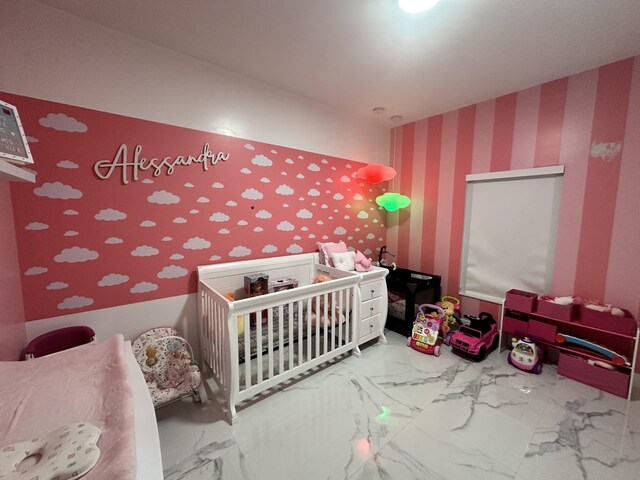 bedroom featuring a crib