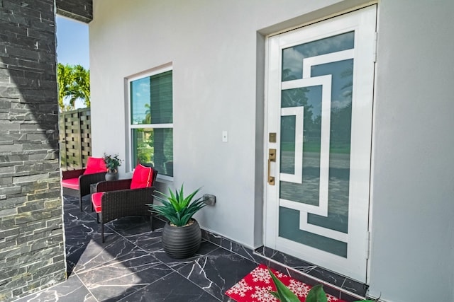 property entrance featuring stucco siding