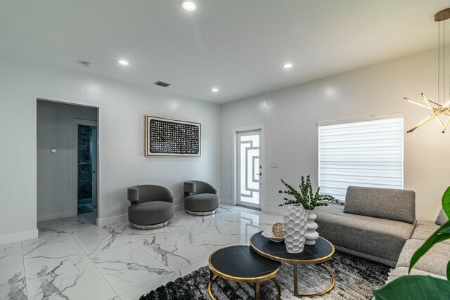 kitchen with sink, wall chimney range hood, stainless steel fridge, decorative light fixtures, and white cabinets