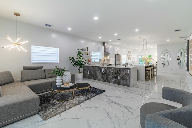 living room with a chandelier, marble finish floor, visible vents, and recessed lighting