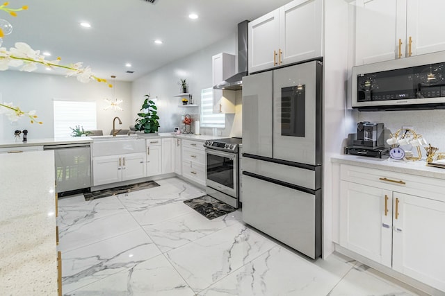 kitchen featuring white cabinets, wall chimney exhaust hood, marble finish floor, stainless steel appliances, and recessed lighting