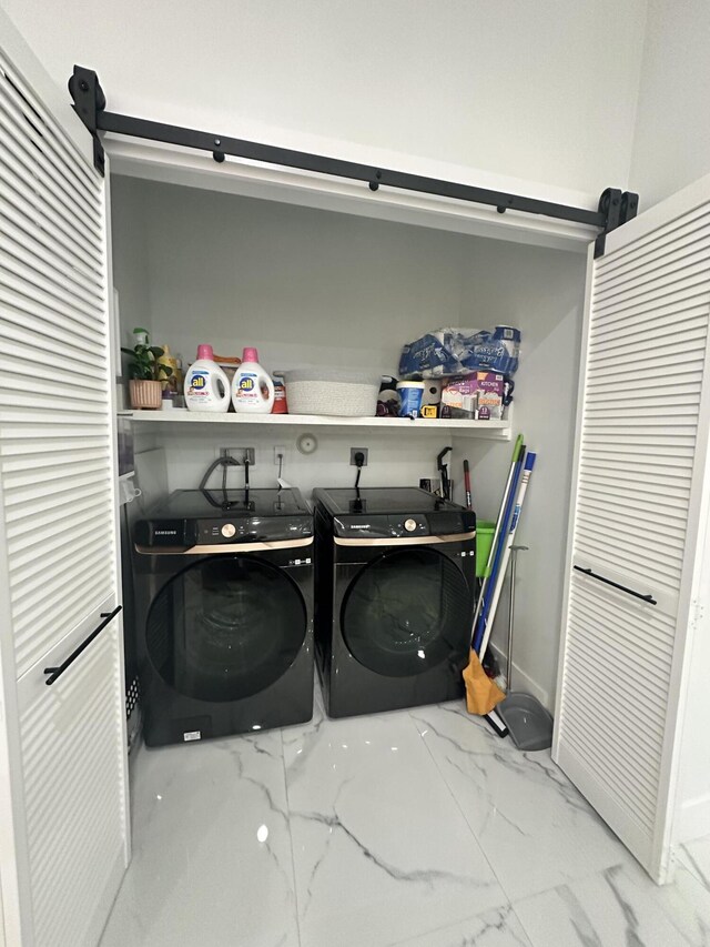 clothes washing area with washing machine and dryer