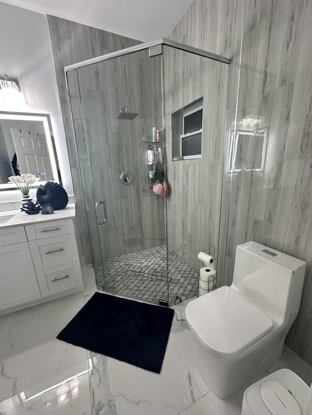 bathroom featuring vanity, toilet, and a shower with door