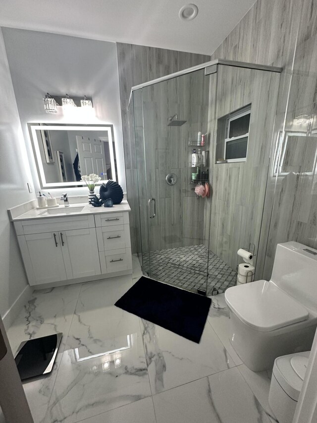 bathroom featuring vanity, toilet, and a shower with door