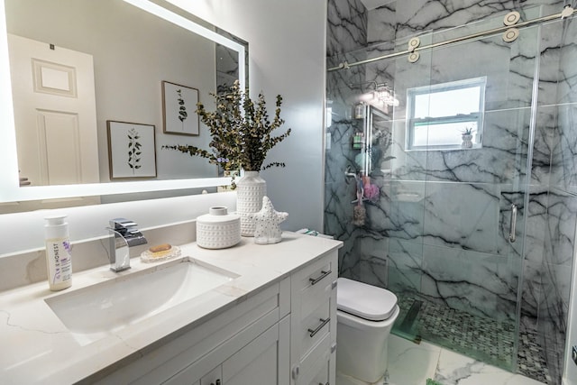 bathroom featuring toilet, marble finish floor, a marble finish shower, and vanity