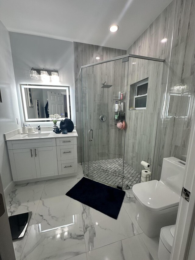 bathroom with vanity, toilet, and a shower with door