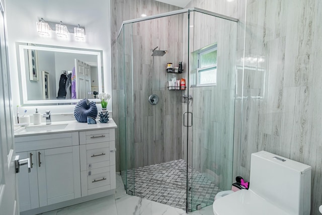 full bathroom featuring marble finish floor, vanity, toilet, and a shower stall