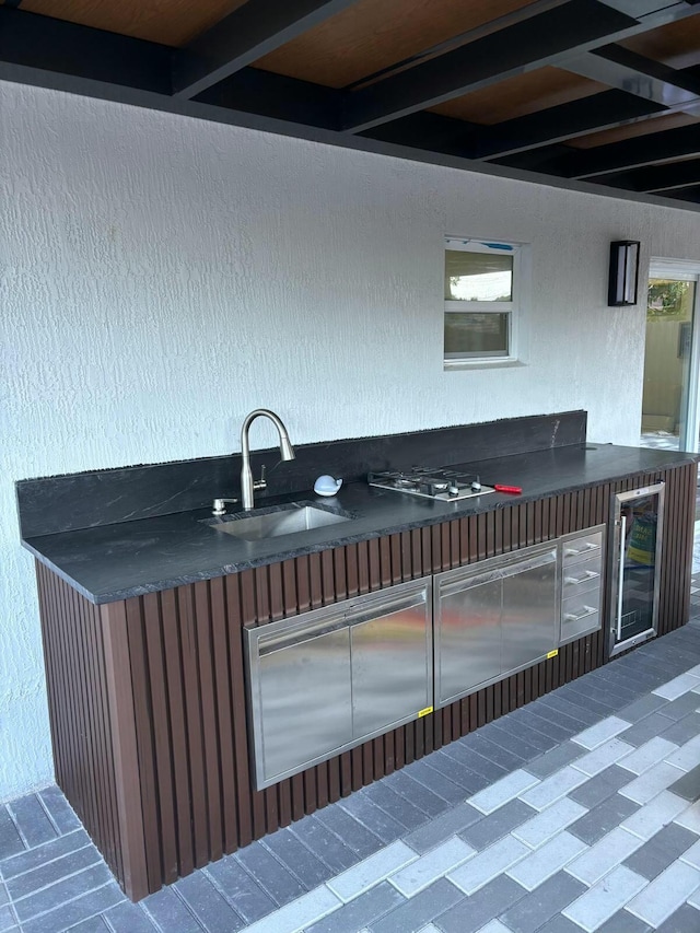 view of patio / terrace featuring wine cooler and sink