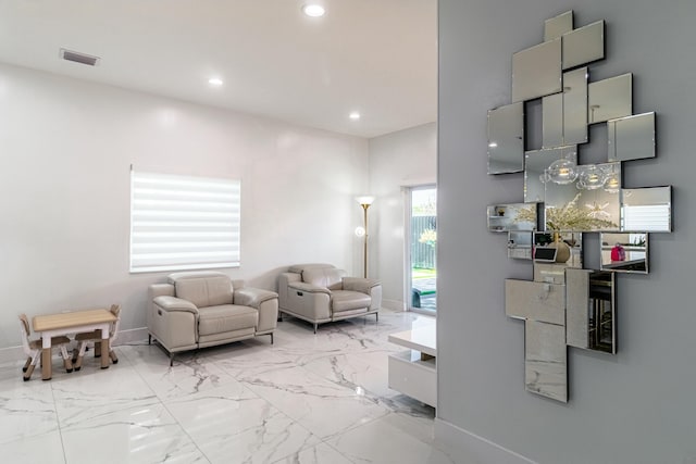 living area with baseboards, marble finish floor, visible vents, and recessed lighting