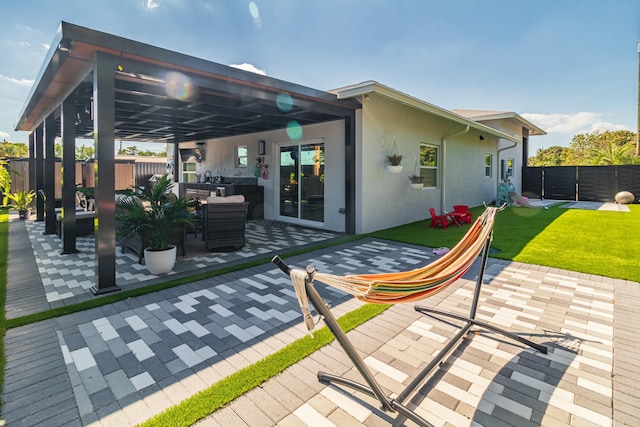 rear view of property with a patio, a lawn, fence private yard, and stucco siding