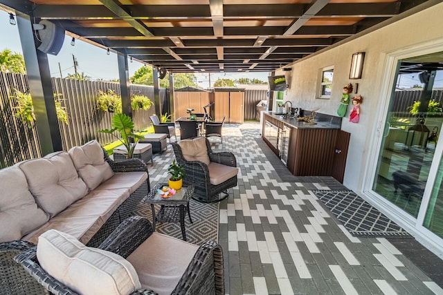 view of patio / terrace with an outdoor kitchen, a fenced backyard, and outdoor lounge area