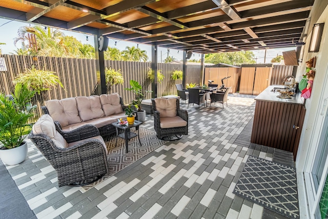 view of patio featuring outdoor lounge area, a fenced backyard, outdoor dining area, and a sink