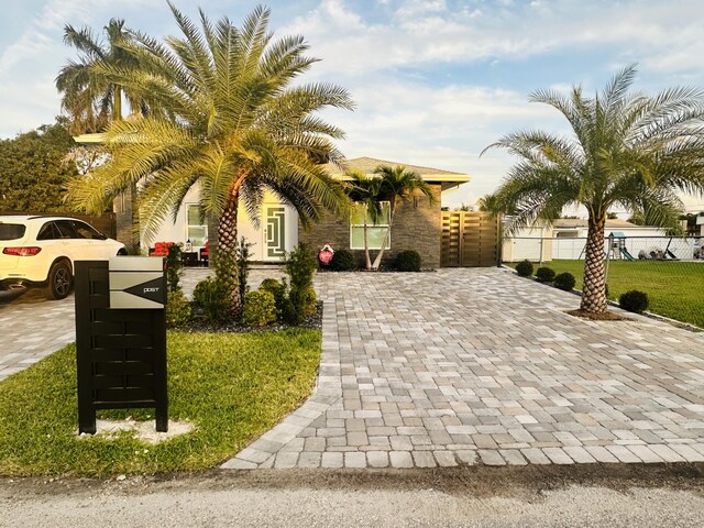 obstructed view of property featuring a front lawn