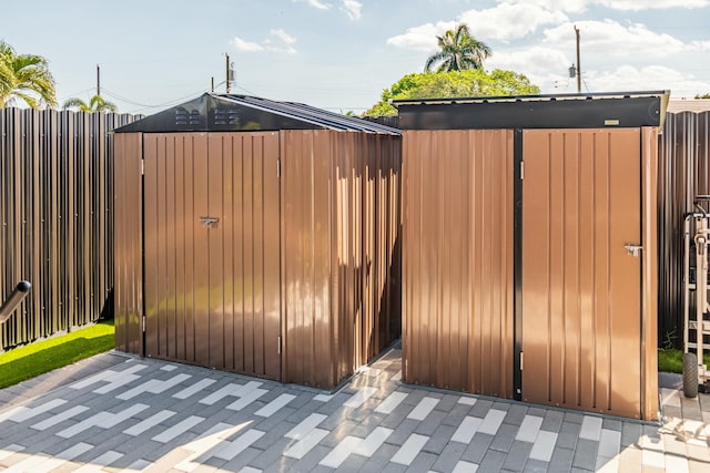 view of gate featuring a patio and fence