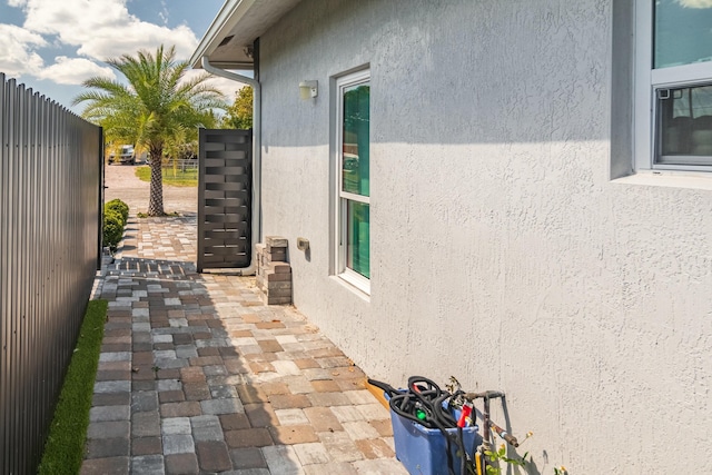 view of home's exterior featuring a patio area, fence, and stucco siding