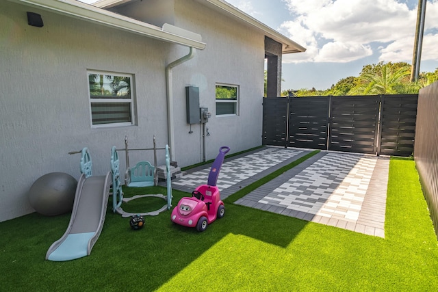 exterior space with a patio area, a gate, and fence