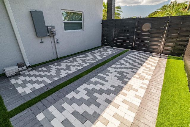 view of patio featuring a gate and fence