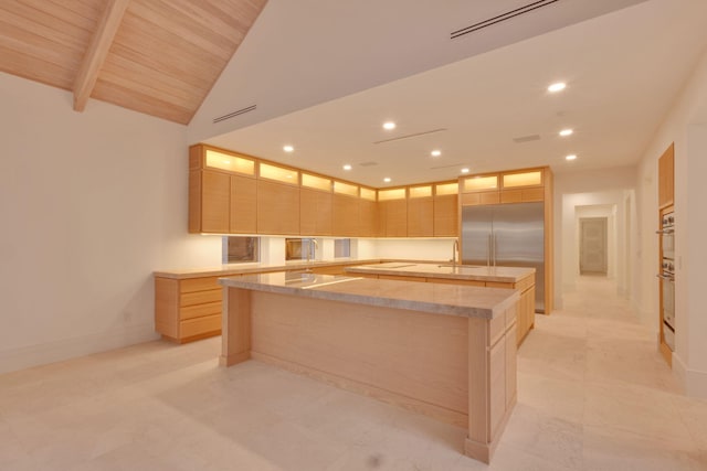 kitchen with a kitchen island with sink, built in refrigerator, light brown cabinetry, lofted ceiling with beams, and wood ceiling