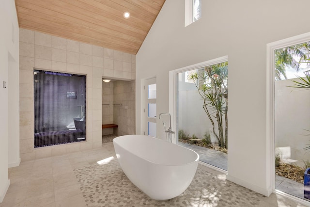 bathroom featuring tile walls, high vaulted ceiling, wooden ceiling, and tile flooring